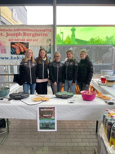 5 Mitglieder der Damenmannschaft stehen an ihre Waffelstand